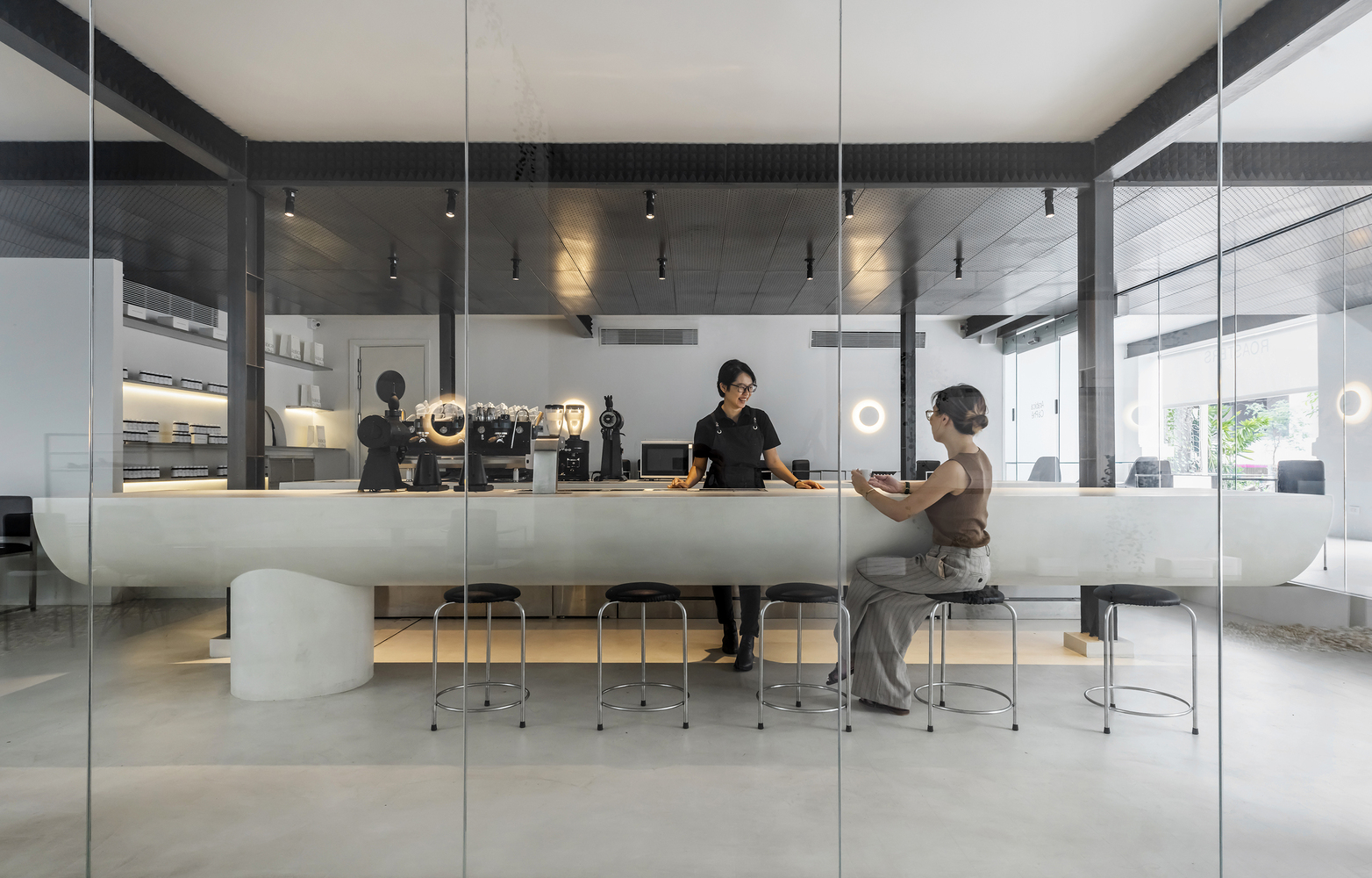 Interior of a modern Bosgaurus Coffee shop with a barista and customer.